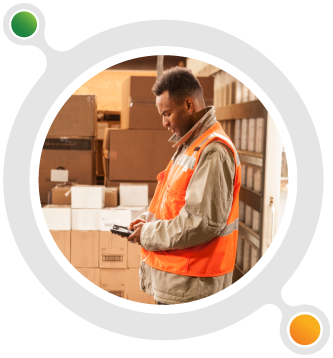 A warehouse worker is looking down at his Honeywell mobile computer.