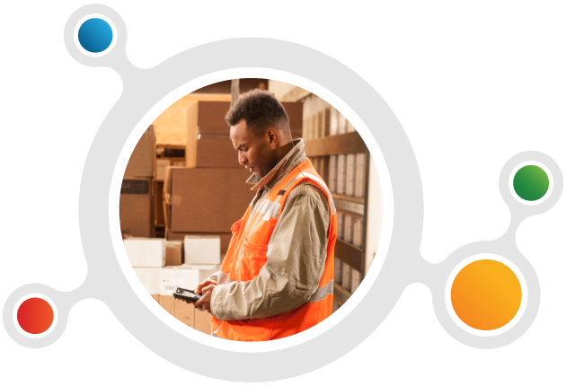 A warehouse worker is entering information into his handheld mobile computer.