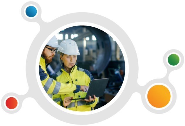 Two engineers are discussing plans on a laptop.