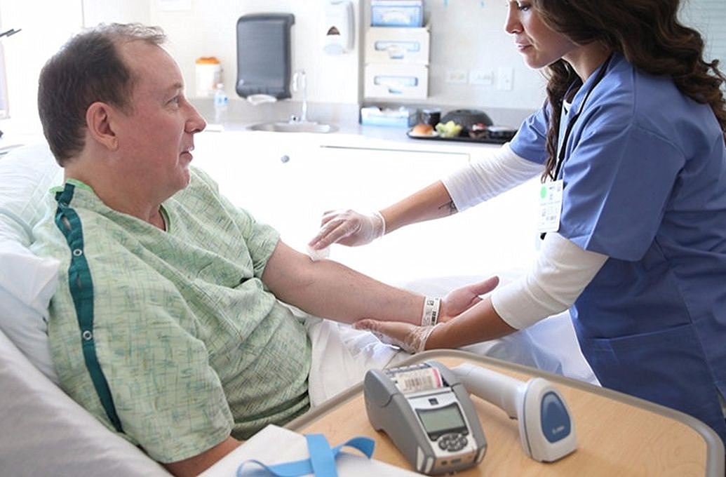 nurse with patient looking for a vein in arm