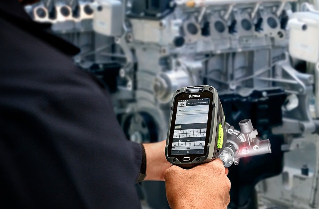 worker on device in warehouse