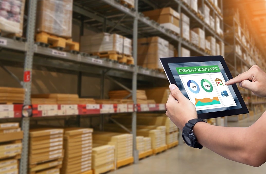 holding tablet in warehouse