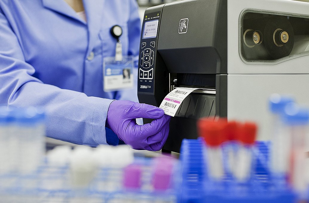 person in Lab using label printer