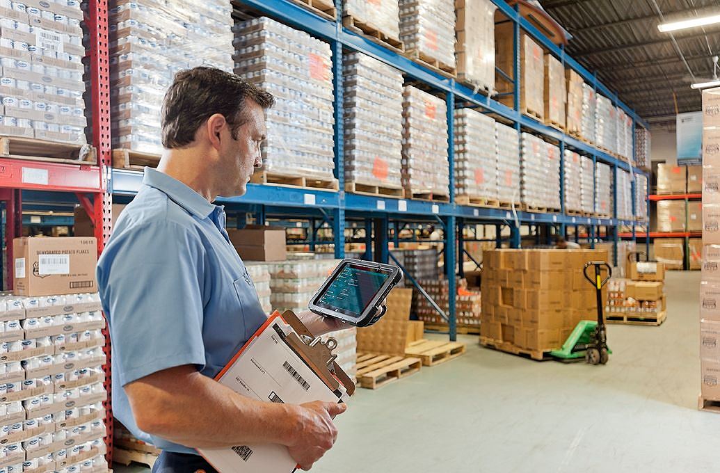 worker using tablet in warehouse